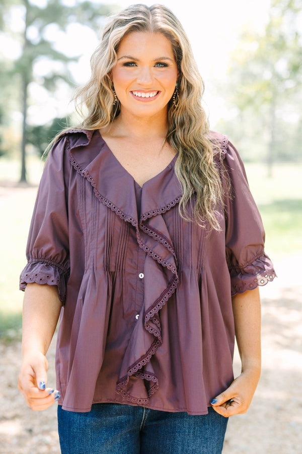 Plus Size brown top with ruffled V-neckline, eyelet trim, button front, and pleated bodice details.