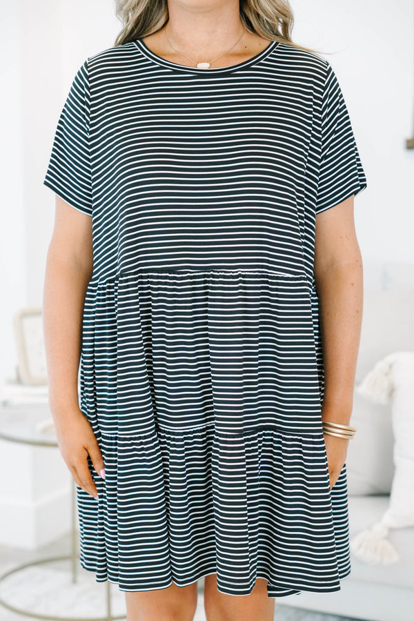 Plus size black and white striped babydoll dress with a flowy tiered skirt and short sleeves.