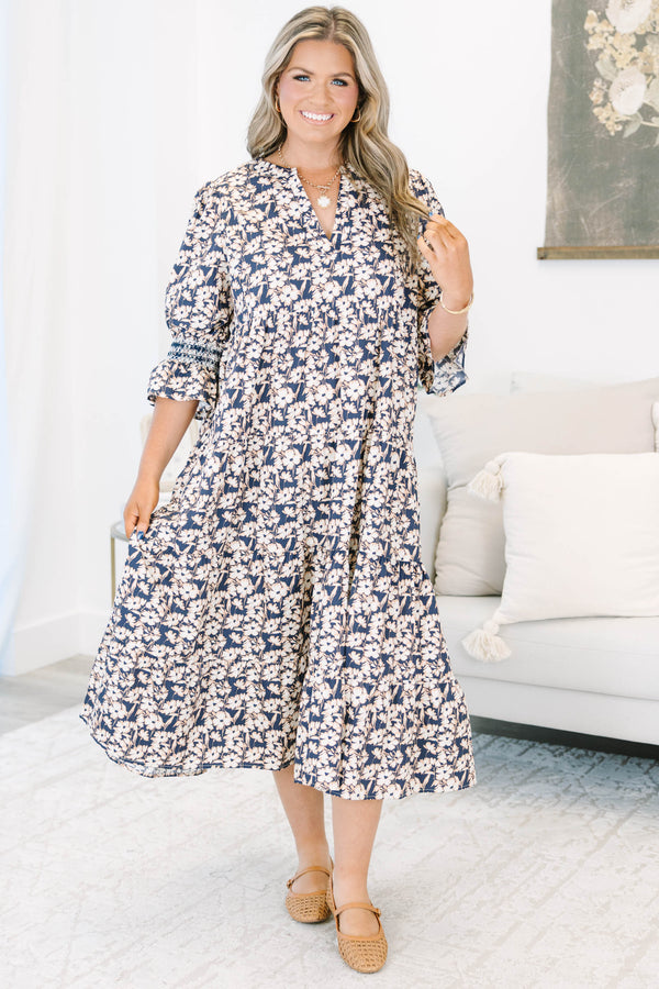 Plus Size black floral tiered midi dress with a V-neckline and three-quarter length puff sleeves.