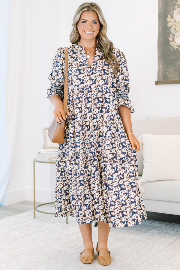 Plus Size black floral tiered midi dress with a V-neckline and three-quarter length puff sleeves.