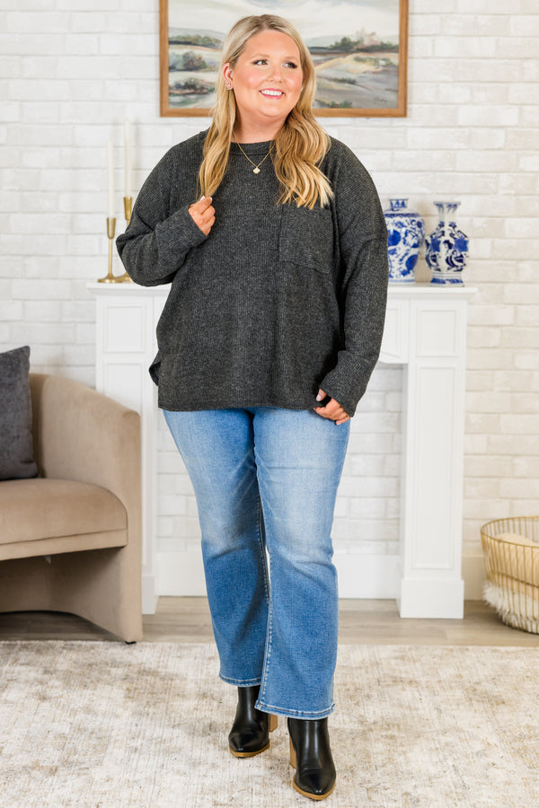 Plus Size black ribbed brushed hacci sweater with a crew neck, chest pocket, and side slits.