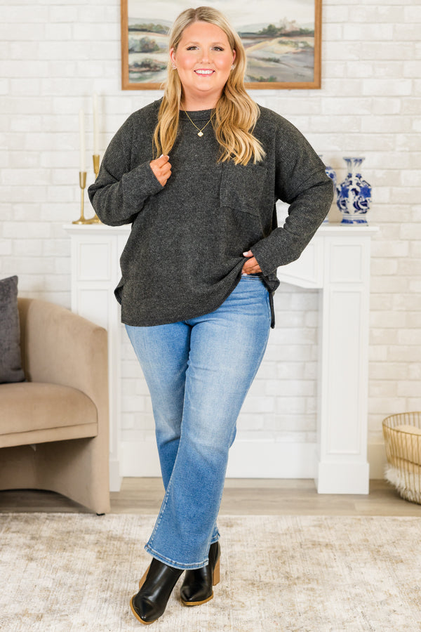 Plus Size black ribbed brushed hacci sweater with a crew neck, chest pocket, and side slits.