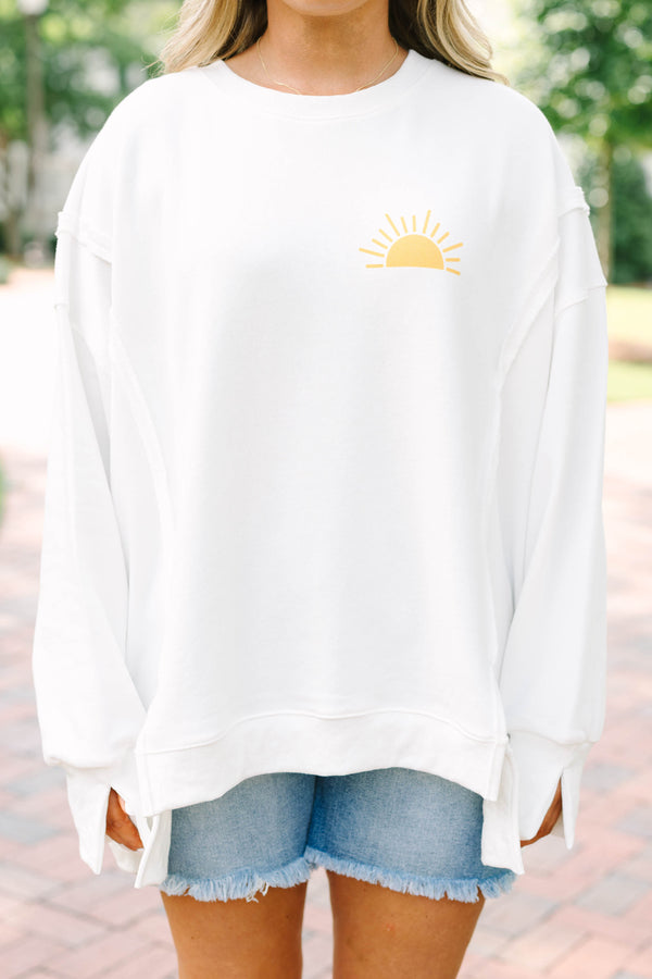 Plus Size ivory crew neck sweatshirt with a yellow sun graphic and frayed denim shorts.