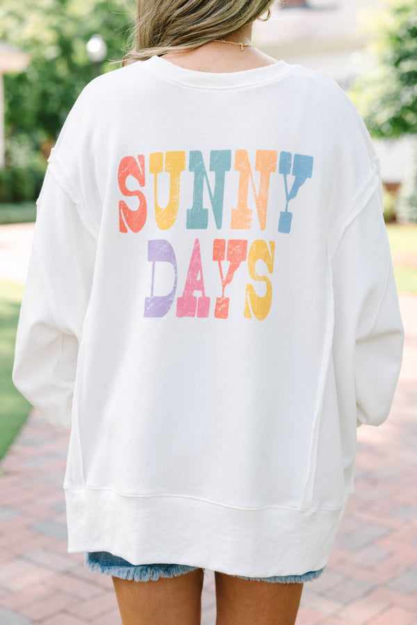 Plus Size ivory crew neck sweatshirt with a yellow sun graphic and frayed denim shorts.