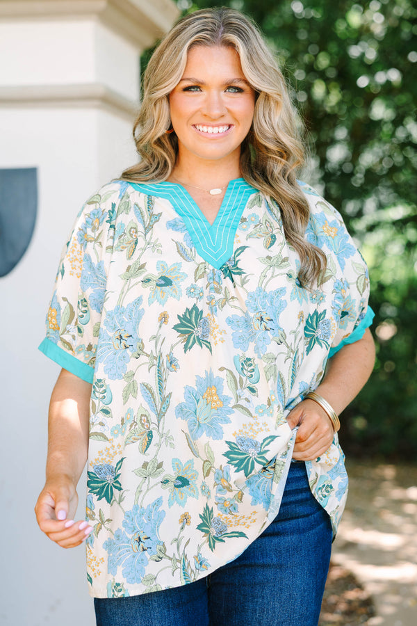 Plus size top in green floral cotton with a flowy fit and V-neckline.