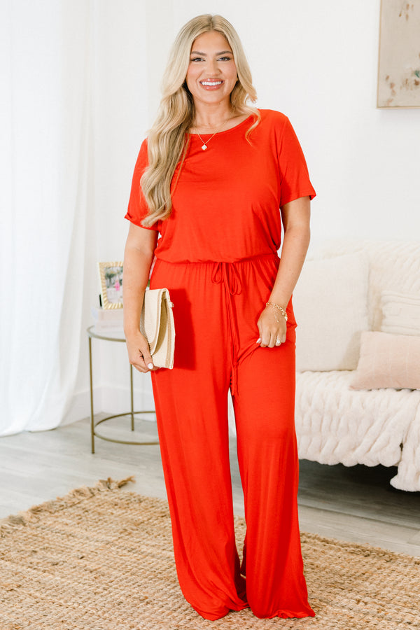 Plus Size red short sleeve jumpsuit with a cinched tie waist and wide-leg pants.