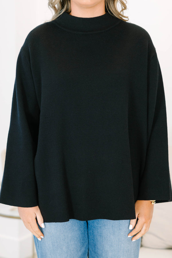 Plus Size black oversized knit sweater with a mock neckline and wide long sleeves.