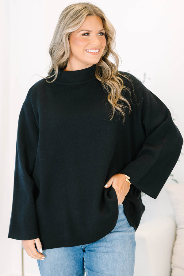 Plus Size black oversized knit sweater with a mock neckline and wide long sleeves.