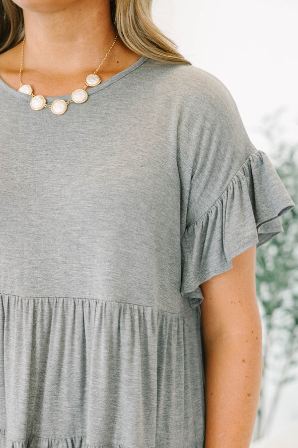 Plus Size charcoal grey tiered tunic with ruffled short sleeves and a flowy, relaxed fit.