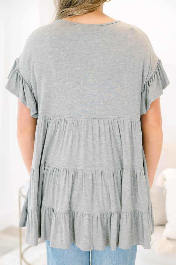 Plus Size charcoal grey tiered tunic with ruffled short sleeves and a flowy, relaxed fit.