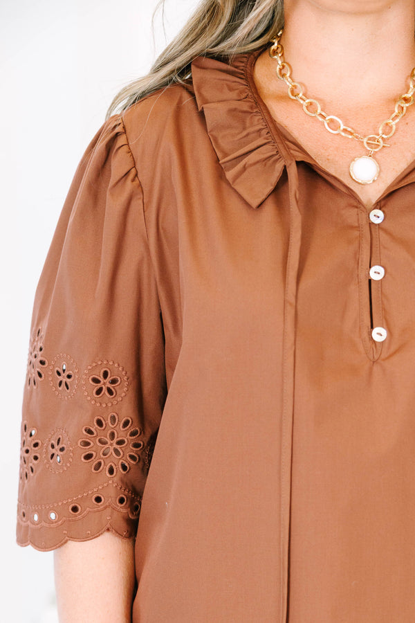 Plus Size brown short sleeve top with eyelet embroidery on the sleeves and a button-up neckline.