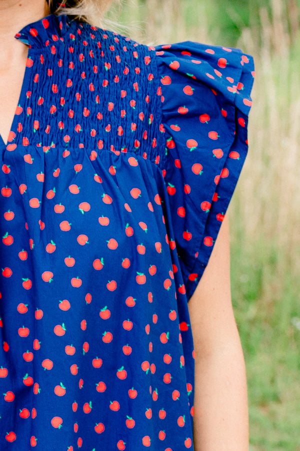 Chic Soul plus size clothing, navy short sleeve top with v cutout along neckline with collar and ruffle sleeve detail with small red apple print