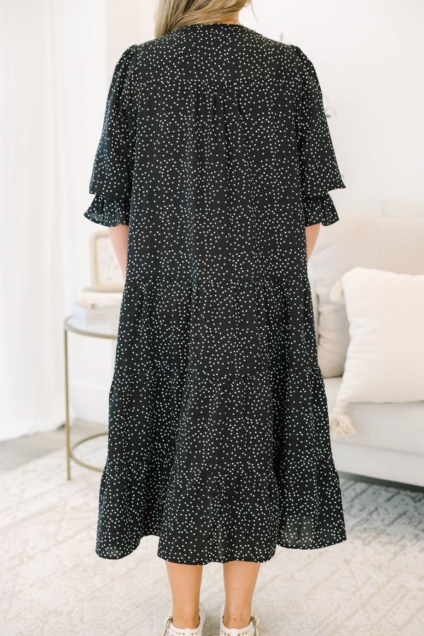 Plus size black polka dot tiered midi dress with a flowy fit and ruffled puff sleeves.