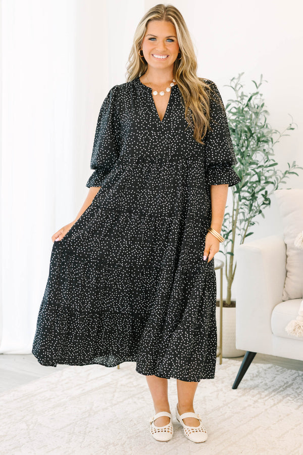 Plus size black polka dot tiered midi dress with a flowy fit and ruffled puff sleeves.