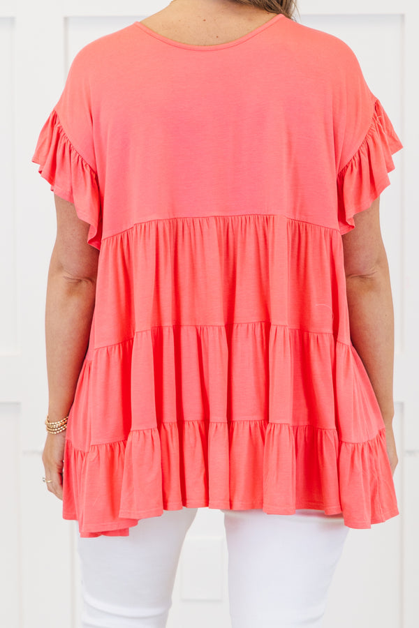 Plus Size coral tiered tunic top with ruffled short sleeves and a flowy fit.