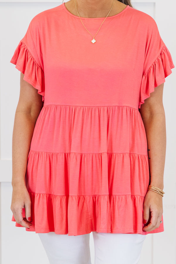 Plus Size coral tiered tunic top with ruffled short sleeves and a flowy fit.