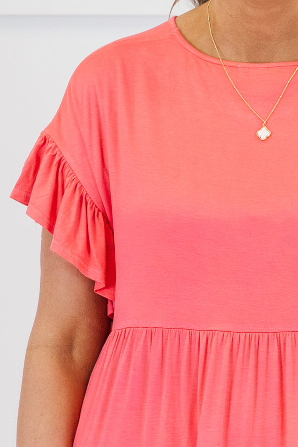 Plus Size coral tiered tunic top with ruffled short sleeves and a flowy fit.
