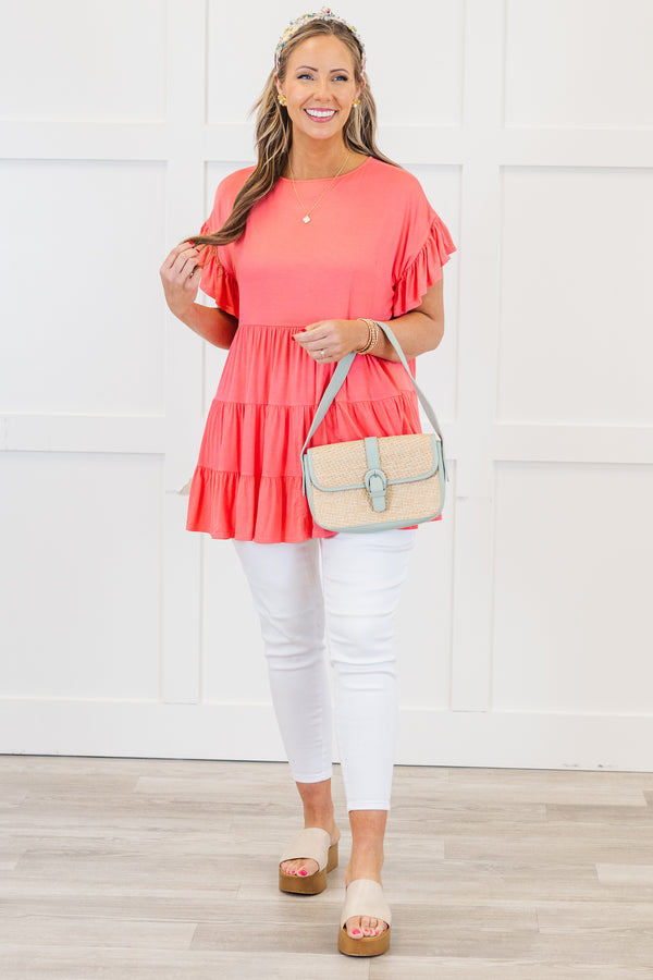 Plus Size coral tiered tunic top with ruffled short sleeves and a flowy fit.