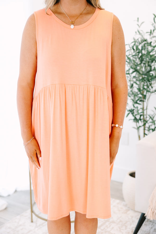Plus Size sleeveless coral babydoll dress with a round neckline and side pockets.