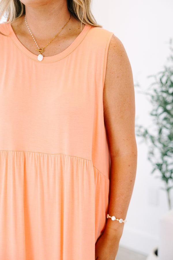 Plus Size sleeveless coral babydoll dress with a round neckline and side pockets.