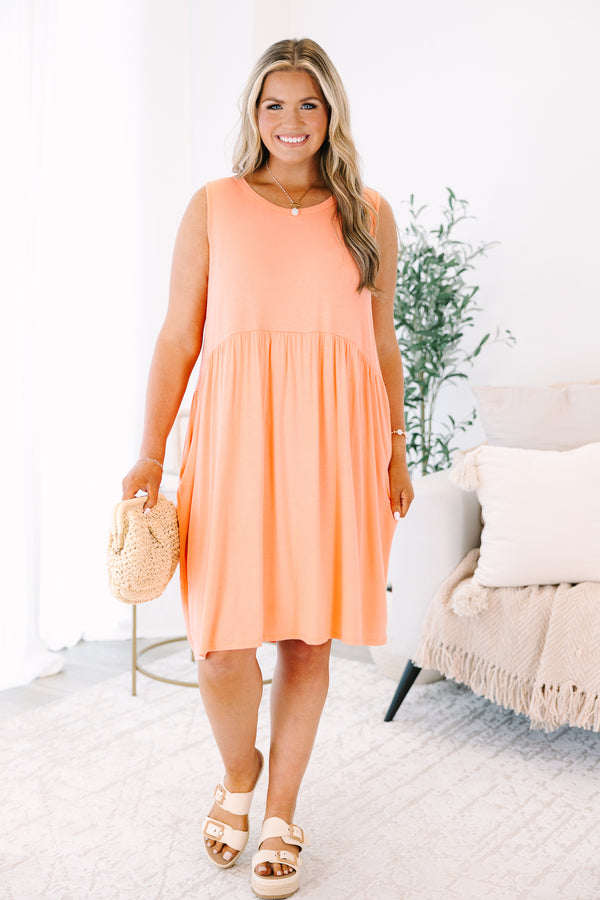 Plus Size sleeveless coral babydoll dress with a round neckline and side pockets.