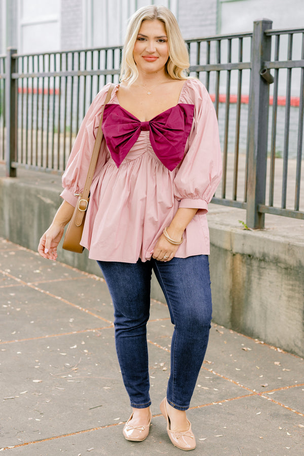 Chic Soul plus size clothing, light pink long sleeve babydoll top with an oversized maroon bow on the chest
