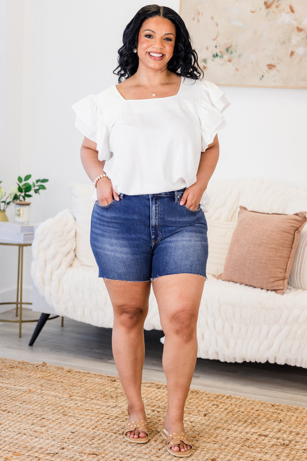 Chic Soul Plus size clothing, Dark-washed jean shorts with a slight distressed fringe at the end of each short leg 
