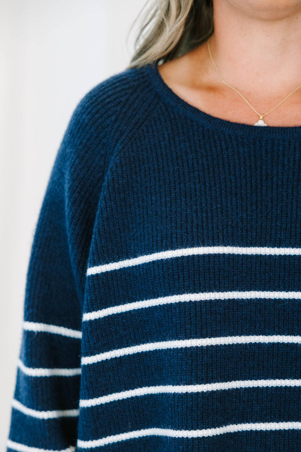 Plus Size navy blue and white horizontal striped sweater with a crew neckline and long sleeves.