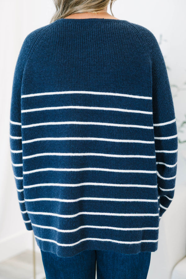 Plus Size navy blue and white horizontal striped sweater with a crew neckline and long sleeves.