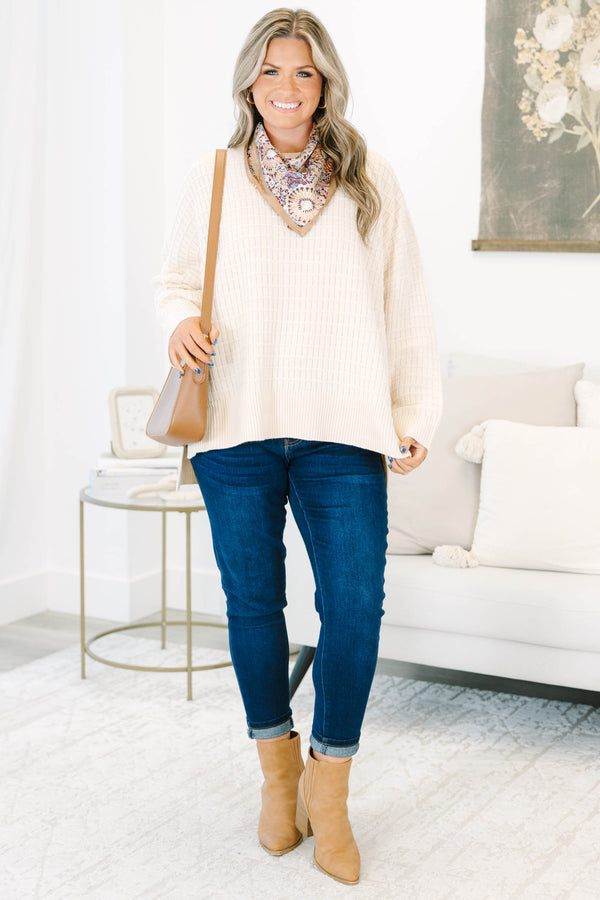 Plus size cream oversized knit sweater with a textured grid pattern and side slits.