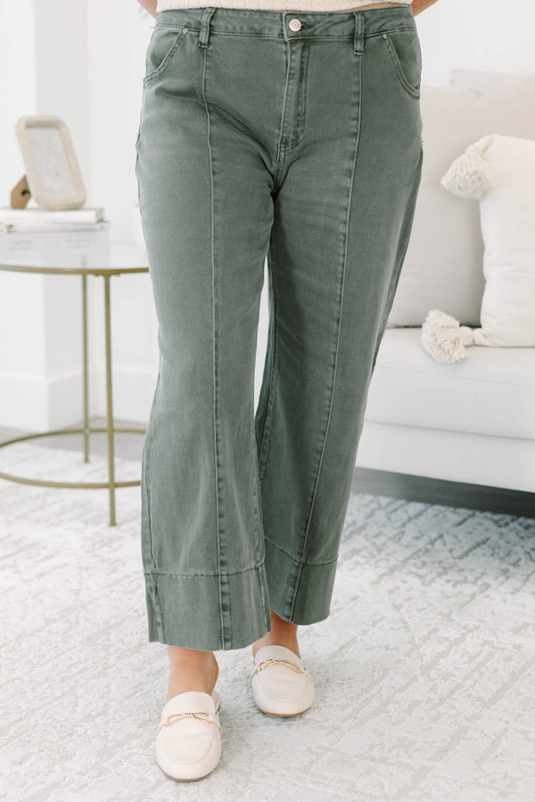 Plus size dark olive wide leg jeans with a high waist, front seam detail, and a relaxed fit.