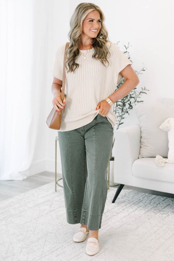 Plus size dark olive wide leg jeans with a high waist, front seam detail, and a relaxed fit.