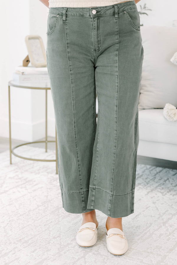 Plus size dark olive wide leg jeans with a high waist, front seam detail, and a relaxed fit.