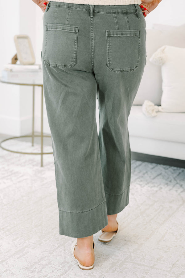 Plus size dark olive wide leg jeans with a high waist, front seam detail, and a relaxed fit.