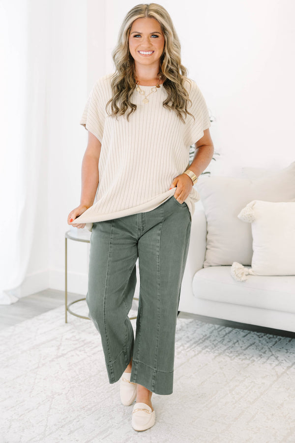 Plus size dark olive wide leg jeans with a high waist, front seam detail, and a relaxed fit.