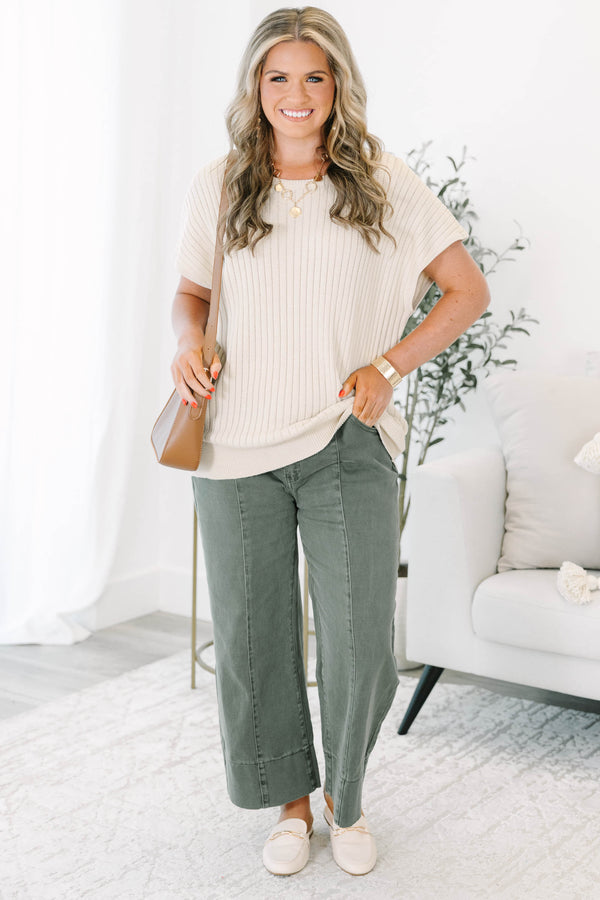Plus size dark olive wide leg jeans with a high waist, front seam detail, and a relaxed fit.