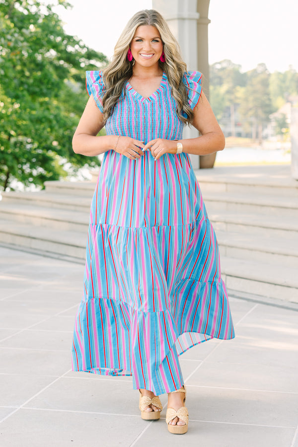 Plus Size blue tiered maxi dress with multi-colored stripes, smocked bodice, and flutter sleeves.