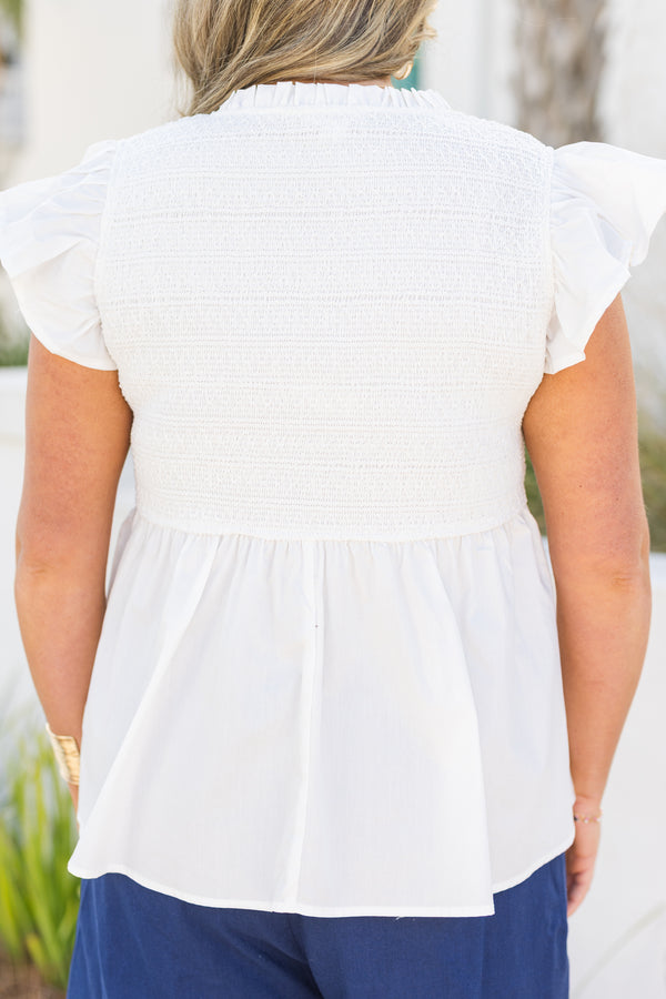 Chic Soul plus size clothing, white top with flutter sleeves and smocked detailing on the chest area and then a flare out from under the bust as well a v-neckline 