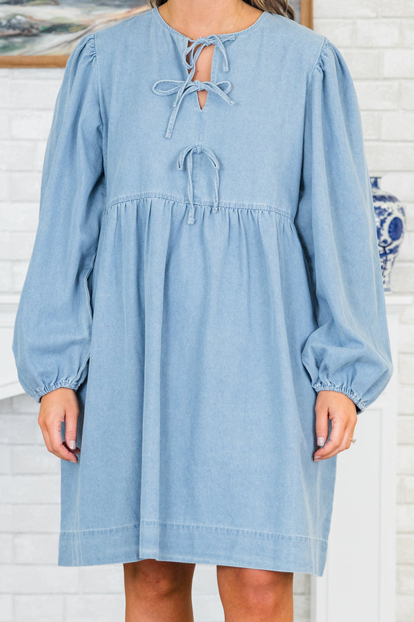 Plus Size light denim babydoll dress with a split v-neck, front bow details, and balloon sleeves.