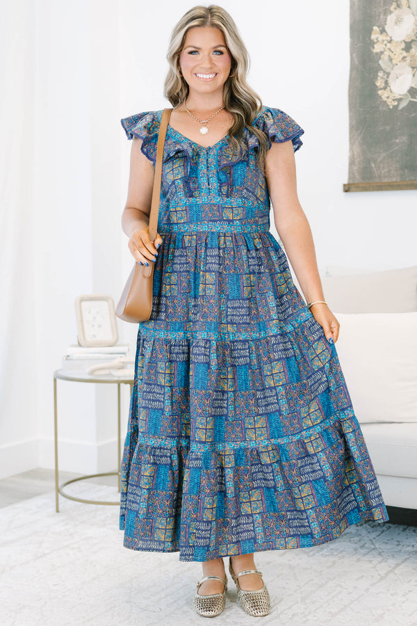Plus Size purple and blue patterned tiered maxi dress with ruffle cap sleeves and a V-neckline.