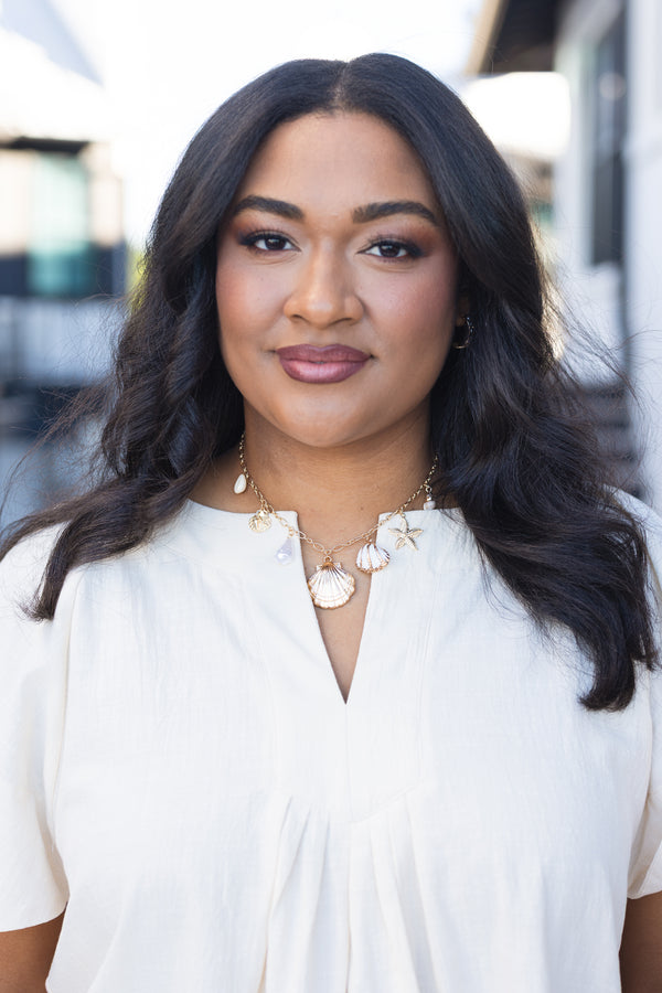 Chic Soul plus size clothing, gold necklace with various seashell charms hanging of the gold chain 