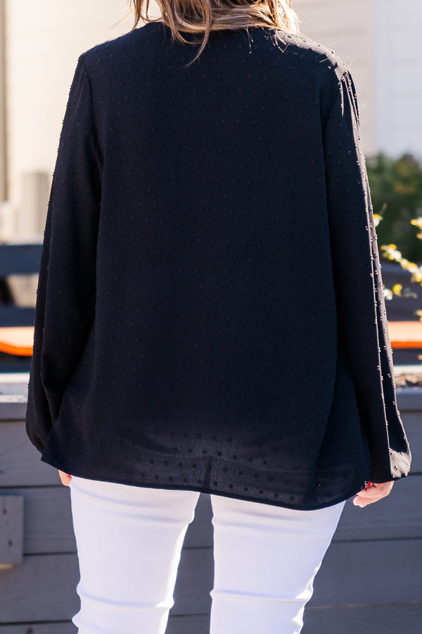 Plus Size black bubble sleeve top with a raised polka dot pattern and ruffled V-neckline.