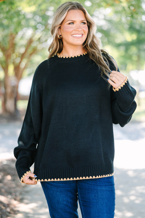 Plus size black knit sweater with tan scalloped trim on the crew neck, cuffs, and hem.