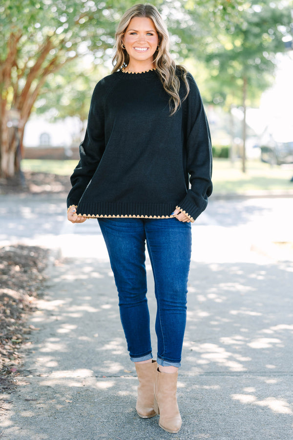 Plus size black knit sweater with tan scalloped trim on the crew neck, cuffs, and hem.