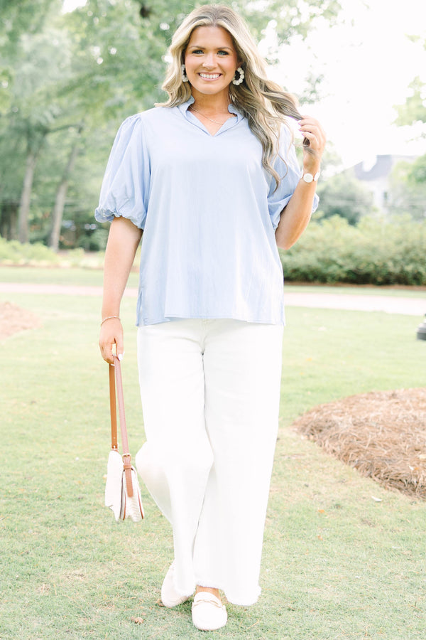 Plus Size light blue top with puff sleeves, a v-neckline, and a relaxed fit.