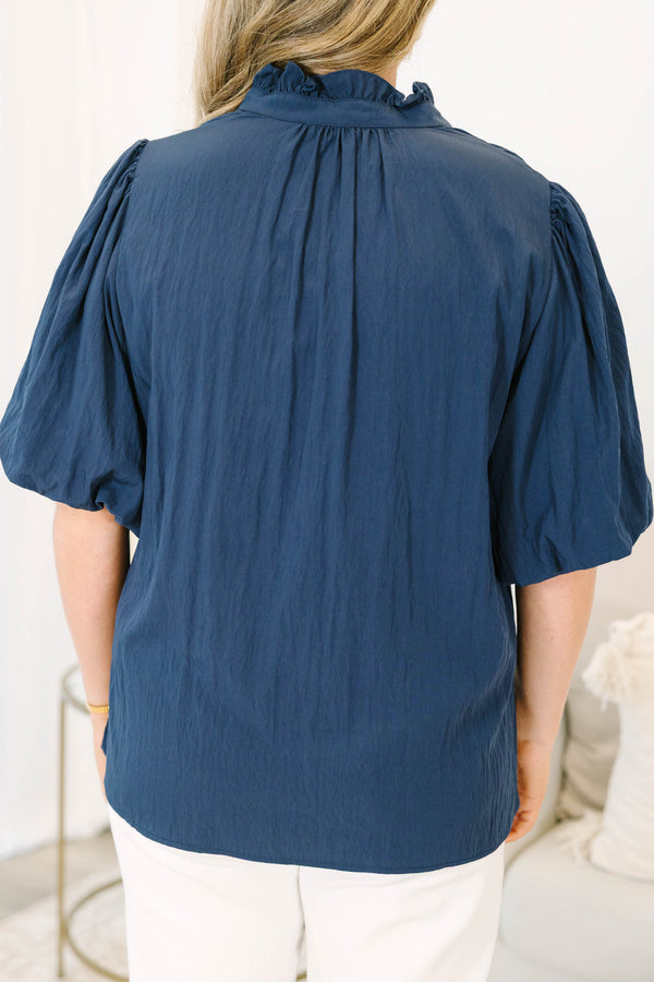Plus Size navy blue rayon-blend top with a v-neckline, ruffled collar, and puff elbow-length sleeves.