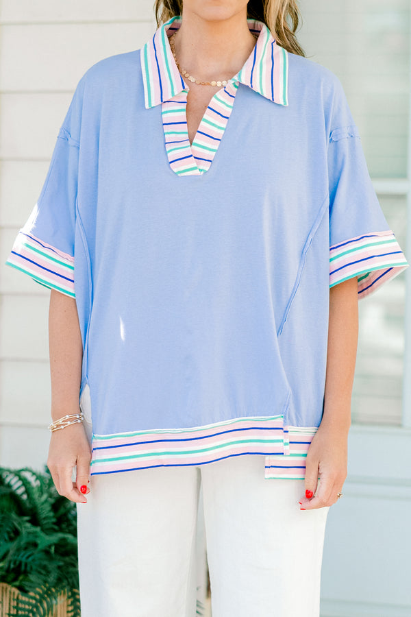 Chic Soul Plus size clothing, periwinkle casual top with short sleeves and a white cuff with colorful stripes on the bottom of the shirt, neckline, and end of the sleeves 
