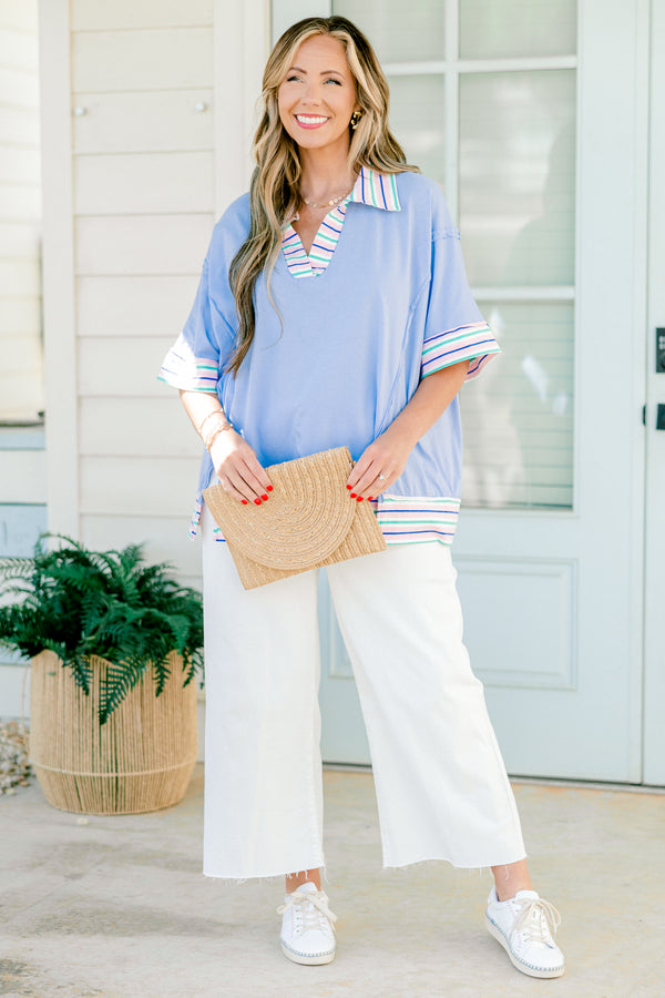 Chic Soul Plus size clothing, periwinkle casual top with short sleeves and a white cuff with colorful stripes on the bottom of the shirt, neckline, and end of the sleeves 
