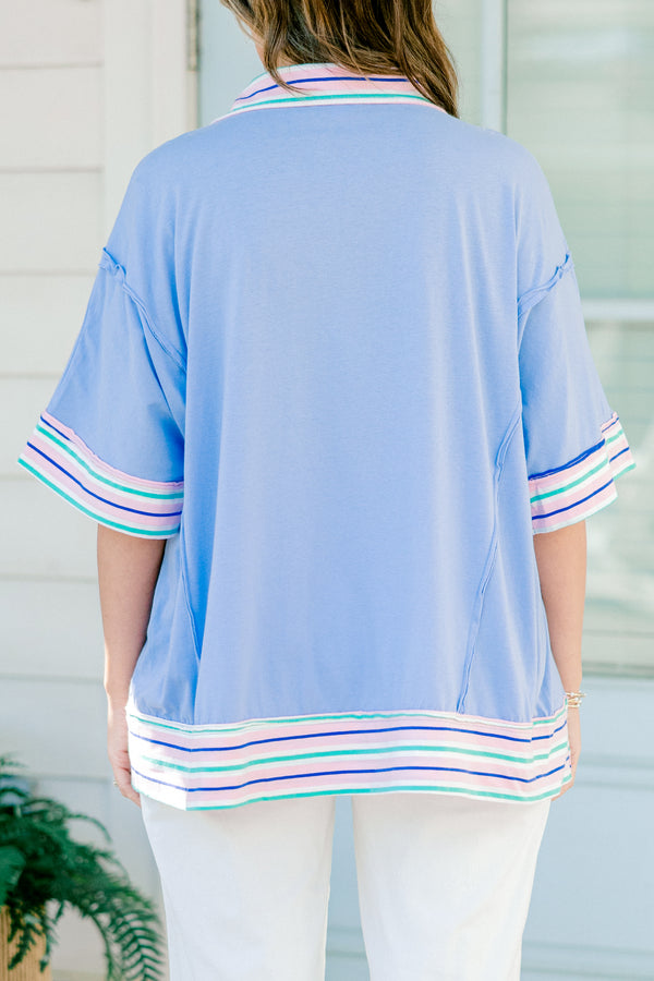 Chic Soul Plus size clothing, periwinkle casual top with short sleeves and a white cuff with colorful stripes on the bottom of the shirt, neckline, and end of the sleeves 
