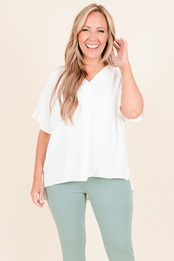 Plus Size off white flowy short sleeve top with a V-neckline and light polyester fabric.